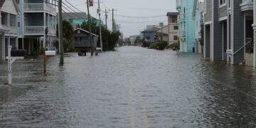 Coastal street flooding on Carolina Beach, NC during king tide.