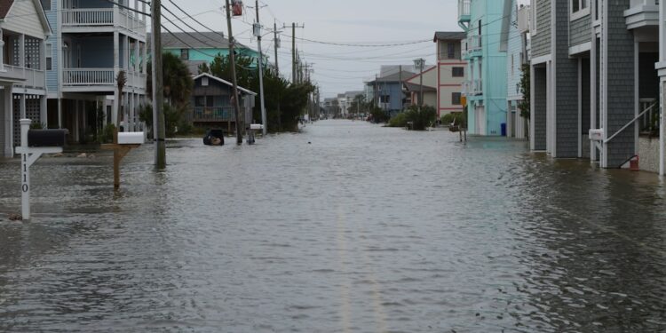 Coastal street flooding on Carolina Beach, NC during king tide.