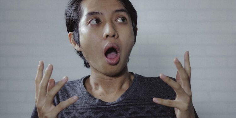 Asian man look side with amazed expression
