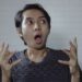 Asian man look side with amazed expression