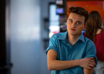 Model and actor Hondo Hendricks rolls up his shirt sleeves while hanging out at Wake Up Call coffeeshop in Blackfoot, Idaho on March 25, 2025.