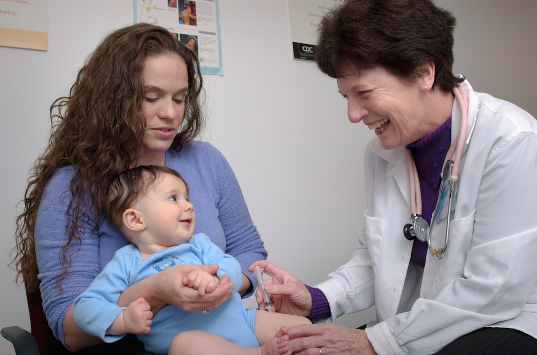 A paediatrician giving a baby a vaccine injection