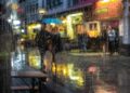 Regendruppels en een paraplu op een natte straat tijdens een bui