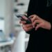 Smartphone met een binnengekomen sms-bericht in een hand